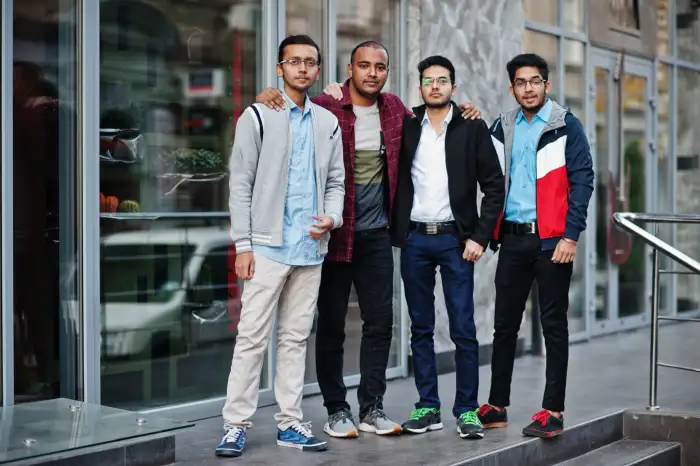 Four Indian computing students standing together as classmates on campus