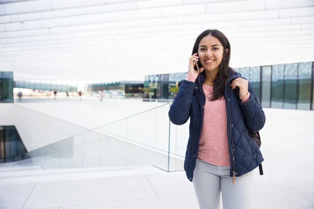 Indian international student talking on the phone while setting up a UKVI account for the UK eVisa system