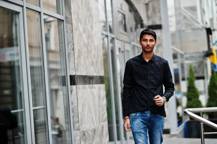 Indian student walking to class on the university campus