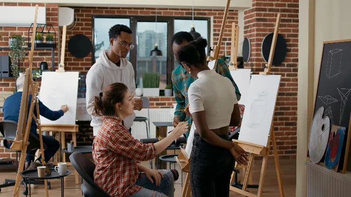Group of students sketching together during a creative arts workshop on campus